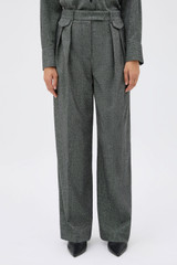 Profile view of model wearing the Oroton Tweed Pleat Pant in CHARCOAL TWEED and Premium blend of 29% polyester, 24% wool, 18% acrylic, 15% silk, 13% viscose, and 1% elastane for Women .