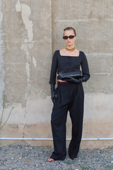 Profile view of model wearing the Oroton Cropped Jacket in Black and Luxurious blend of 97% polyester, 19% wool, and 2% polyurethane for Women .