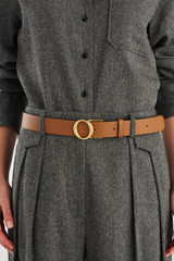 Profile view of model wearing the Oroton Ali Wide Reversible Belt in Black/Cognac and Premium smooth leather for Women .
