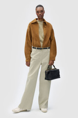 Profile view of model wearing the Oroton Folk Straight Leg Pant in Dark Putty and 96% cotton and 4% spandex blend fabric for Women .