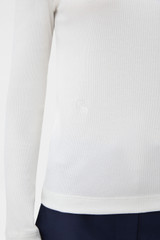 Profile view of model wearing the Oroton Eve Fine Rib Tee in Antique White and 85% cotton and 15% spandex blend fabric for Women .