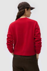 Profile view of model wearing the Oroton WILLOW CARDIGAN in Market Red and 100% merino wool fabric for Women