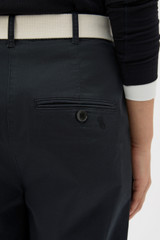 Profile view of model wearing the Oroton Folk Straight Leg Pant in Washed Black and 96% cotton and 4% spandex blend fabric for Women .
