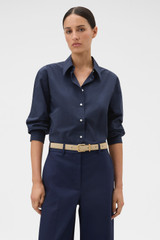Profile view of model wearing the Oroton Wren Poplin Shirt in North Sea and 100% cotton fabric for Women .