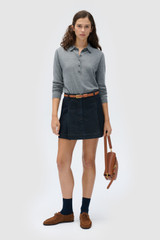 Profile view of model wearing the  FLORA FINE KNIT POLO in Grey Marle and 55% extra fine merino wool and 45% cotton blend fabric for Women