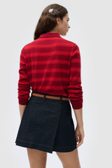 Profile view of model wearing the Oroton Denim Pleat Skirt in Dark Blue and 90% cotton and 10% polysester blend fabric for Women . IP:6