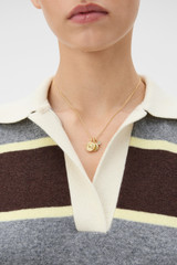 Profile view of model wearing the Oroton Kaia Necklace in Gold and Premium brass material for Women .
