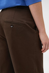 Profile view of model wearing the Oroton Folk Straight Leg Pant in Dark Chocolate and 96% cotton and 4% elastane fabric for Women .