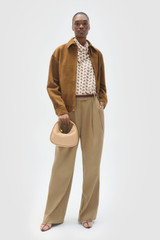 Profile view of model wearing the Oroton Suede Bomber in Teak and 100% soft suede leather material for Women .