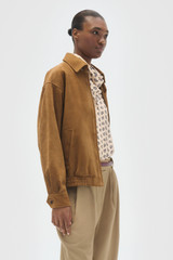 Profile view of model wearing the Oroton Suede Bomber in Teak and 100% soft suede leather material for Women .
