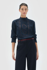 Profile view of model wearing the Oroton Fluid Cutwork Long Sleeve Top in North Sea and 75% acetate and 25% polyester blend fabric for Women .