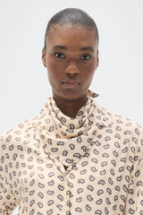 Profile view of model wearing the Oroton Foulard Print Blouse in Winter Peach and 100% silk twill fabric for Women .