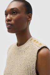 Profile view of model wearing the Oroton Nep Knit Shell in Oat and 65% merino wool, 30% nylon, and 5% alpaca blend fabric for Women .