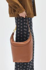 Profile view of model wearing the Oroton Florence Large Hobo in Cognac and Premium smooth leather for Women .