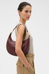 Profile view of model wearing the Oroton Florence Medium Hobo in Currant and Smooth leather material for Women .