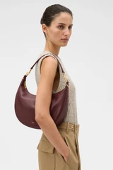 Profile view of model wearing the Oroton Florence Medium Hobo in Currant and Smooth leather material for Women .