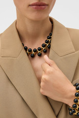 Profile view of model wearing the Oroton Amelie Necklace in Black and Glass material for Women .