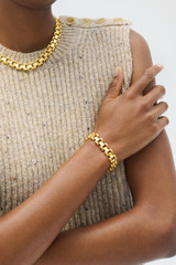 Profile view of model wearing the Oroton Asher Bracelet in Worn Gold and  for Women .
