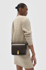 Profile view of model wearing the Oroton Etta Large Day Bag in Dark Chocolate and Premium smooth leather for Women .