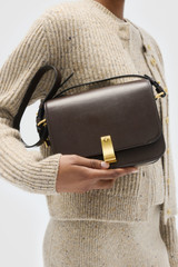 Profile view of model wearing the Oroton Etta Large Day Bag in Dark Chocolate and Premium smooth leather for Women .