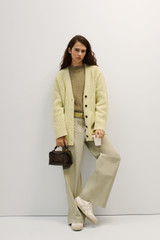 Profile view of model wearing the Oroton Oversized Manstyle Cardigan in Sorbet and 80% wool and 20% nylon fabric for Women .