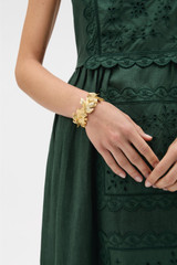 Profile view of model wearing the Oroton Oak Cuff in Worn Gold and Premium brass material for Women .