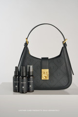 Profile view of model wearing the Oroton Yvonne Signature Baguette in Black and Nylon canvas base cloth material with PVC coating (70% PVC, 30% polyester) for Women .