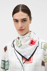 Profile view of model wearing the Oroton Label Print Silk Scarf in White and 100% silk twill fabric for Women .