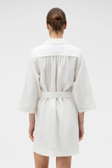 Profile view of model wearing the Oroton Handkerchief Tunic Dress in Antique White and 100% mid-weight linen fabric for Women .