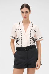 Profile view of model wearing the Oroton Stencil Print Camp Shirt in Soft Peach and 100%  linen fabric for Women .