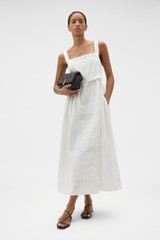 Profile view of model wearing the Oroton Handkerchief Sundress in Antique White and 100% mid-weight linen fabric with a lightly textured surface for Women .