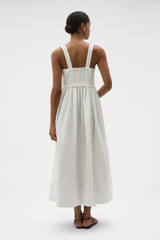 Profile view of model wearing the Oroton Handkerchief Sundress in Antique White and 100% mid-weight linen fabric with a lightly textured surface for Women .