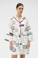 Profile view of model wearing the Oroton Vintage Label Print Tunic Dress in Cream and 100%  linen fabric for Women . IP:2
