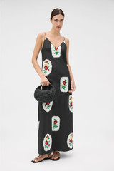 Profile view of model wearing the Oroton Folk Doilie Print Slip Dress in Black and 100% silk fabric for Women .