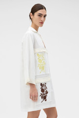 Profile view of model wearing the Oroton Embroidered Tunic Dress in Antique White and 100%  linen fabric for Women .