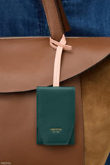Profile view of model wearing the Oroton Cecile Luggage Tag in IVY/MELON and Premium crackle leather for Women .