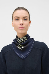 Profile view of model wearing the Oroton Marine Fish Print Scarf in North Sea and 100% silk twill fabric for Women .