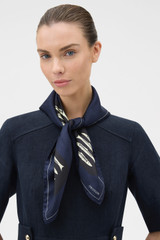 Profile view of model wearing the Oroton Marine Fish Print Scarf in North Sea and 100% silk twill fabric for Women .