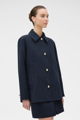 Profile view of model wearing the Oroton Button Detail Jacket in NORTH SEA and 100% bonded heavy linen fabric for Women .