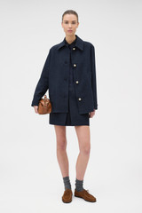 Profile view of model wearing the Oroton Button Detail Jacket in NORTH SEA and 100% bonded heavy linen fabric for Women .