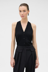 Profile view of model wearing the Oroton Fine Gauge Knit Waistcoat in BLACK and 100% fine gauge merino wool fabric for Women .