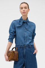 Profile view of model wearing the Oroton Denim Tie Neck Shirt in Denim and 100% cotton fabric for Women .