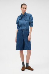 Profile view of model wearing the Oroton  Denim Bermuda in DENIM and 90% cotton and 10% polyester blend fabric for Women .