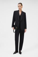 Profile view of model wearing the Oroton Dinner Jacket in BLACK and 53% polyester, 43% wool, and 4% lycra Italian wool blend for Women .