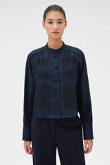 Profile view of model wearing the Oroton Doilie Detail Top in NORTH SEA and 100% linen fabric for Women .