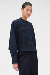 Profile view of model wearing the Oroton Doilie Detail Top in NORTH SEA and 100% linen fabric for Women .