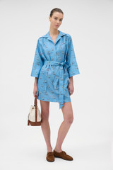 Profile view of model wearing the Oroton Marine Yacht Tunic Dress in SAILOR BLUE and 100% midweight linen fabric for Women .