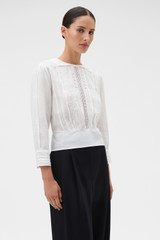Profile view of model wearing the Oroton Lace Detail Blouse in Antique White and 100% linen fabric for Women .