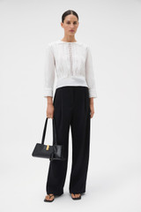 Profile view of model wearing the Oroton Lace Detail Blouse in Antique White and 100% linen fabric for Women .