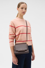 Profile view of model wearing the Oroton Elm Small Satchel in Coffee Bean and Premium smooth pebble leather for Women .